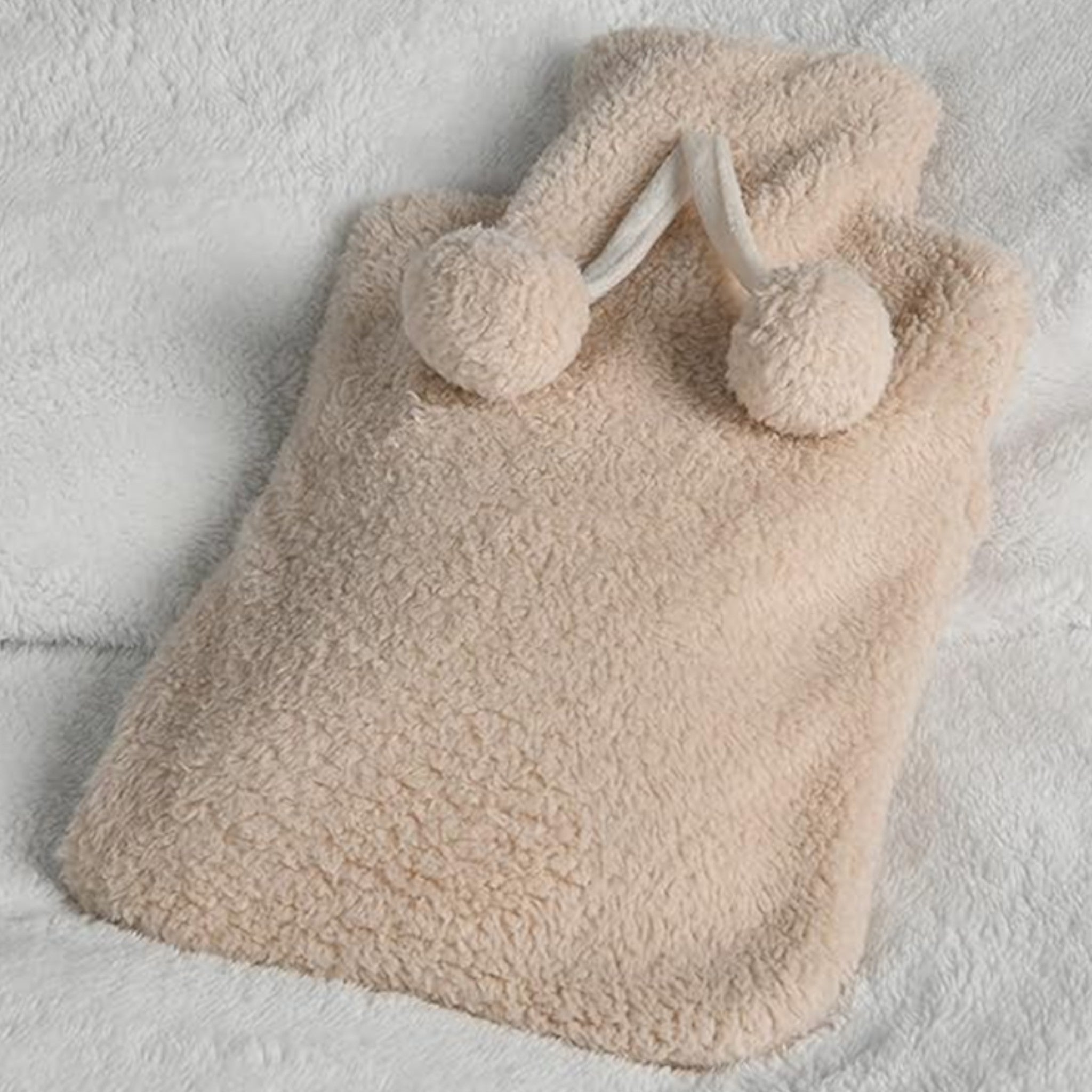 Elite Heat hot water bottle with removable plush cover, perfect for winter in natural